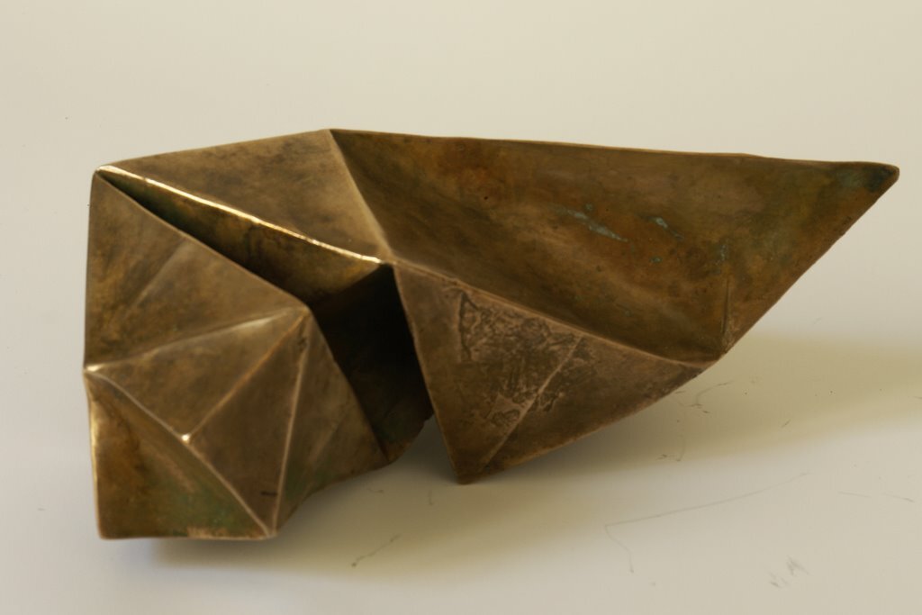 I folded a lot of papers when I stopped being a bronze sculptor. A need to lighten up, no doubt. However, I sometimes convert paper into bronze. In this case, I use wax/lost paper instead of the traditional lost wax. I use thin paper because it deforms and inflections linked to the tensions of folding appear and leave a trace. These stigmata of the action of folding paper tell the story of the formation of volume in the manner of a tree’s bark, which cracks and deforms as it grows.